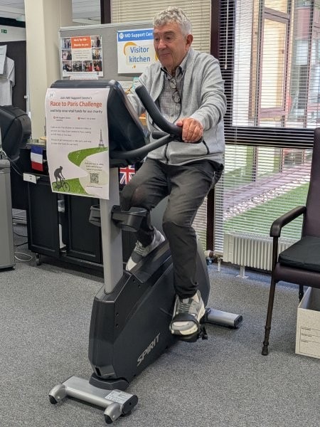 An older gentleman on a stationary bike