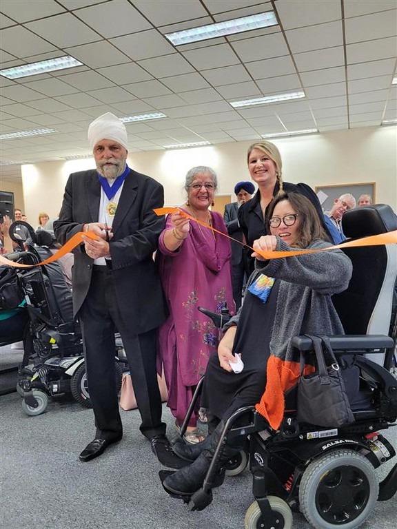 Four people cutting the ribbon at our new headquarters