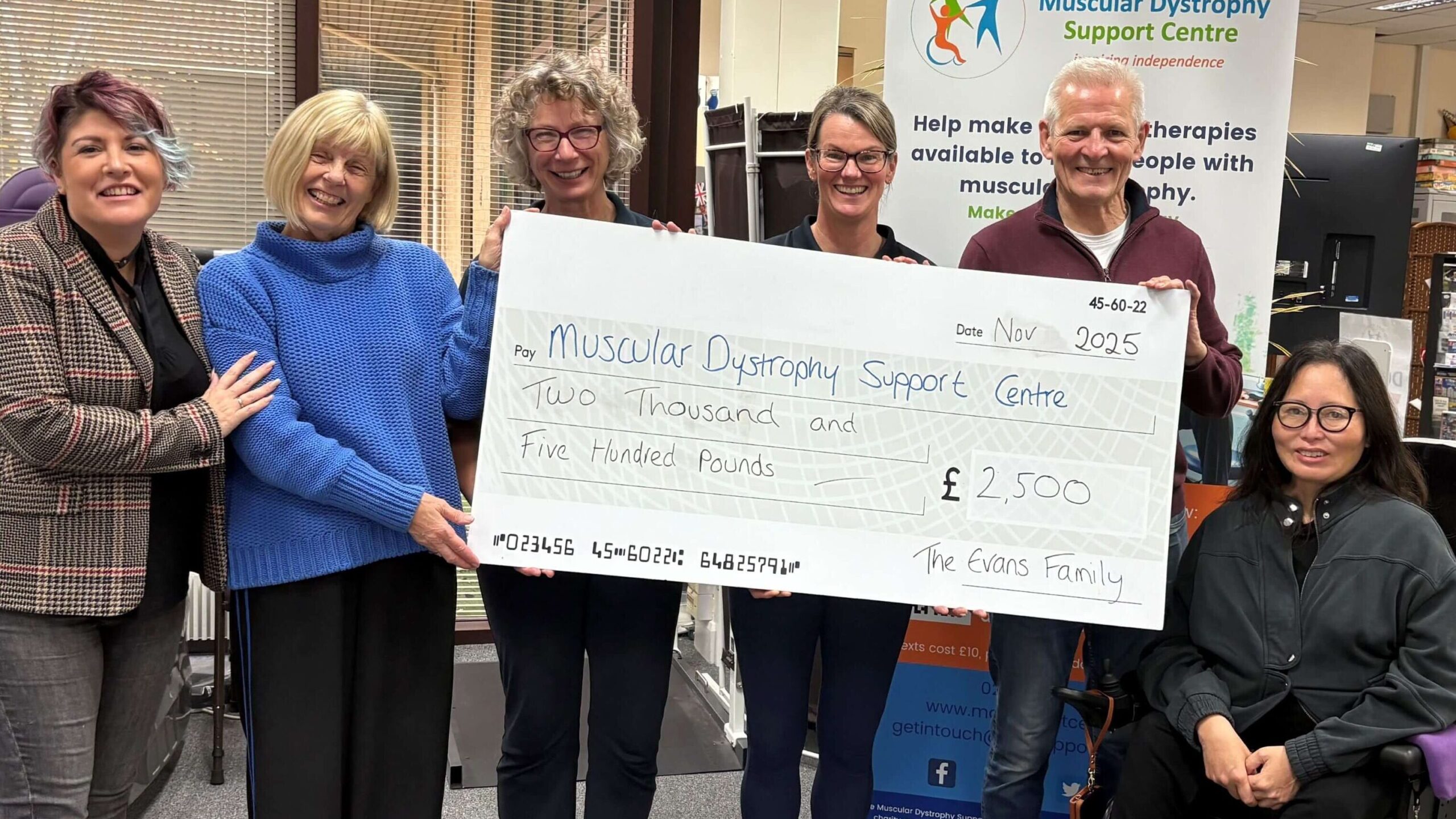 A group of people presenting a large cheque