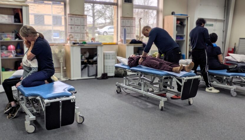 People receiving physiotherapy in our clinic. There are four people receiving treatment on therapy beds.
