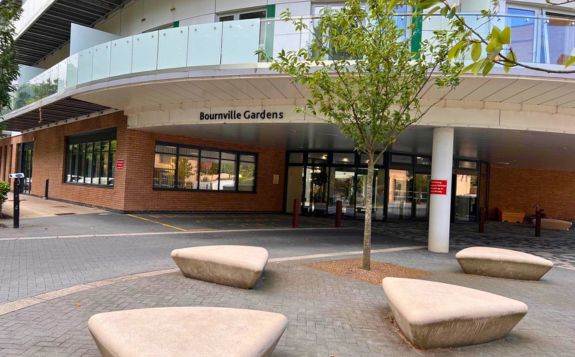 Brick building entrance to MD Support Centre Coventry with yellow-framed glass doors, signage displaying unit numbers 9 and 10, and a banner beside the doorway.