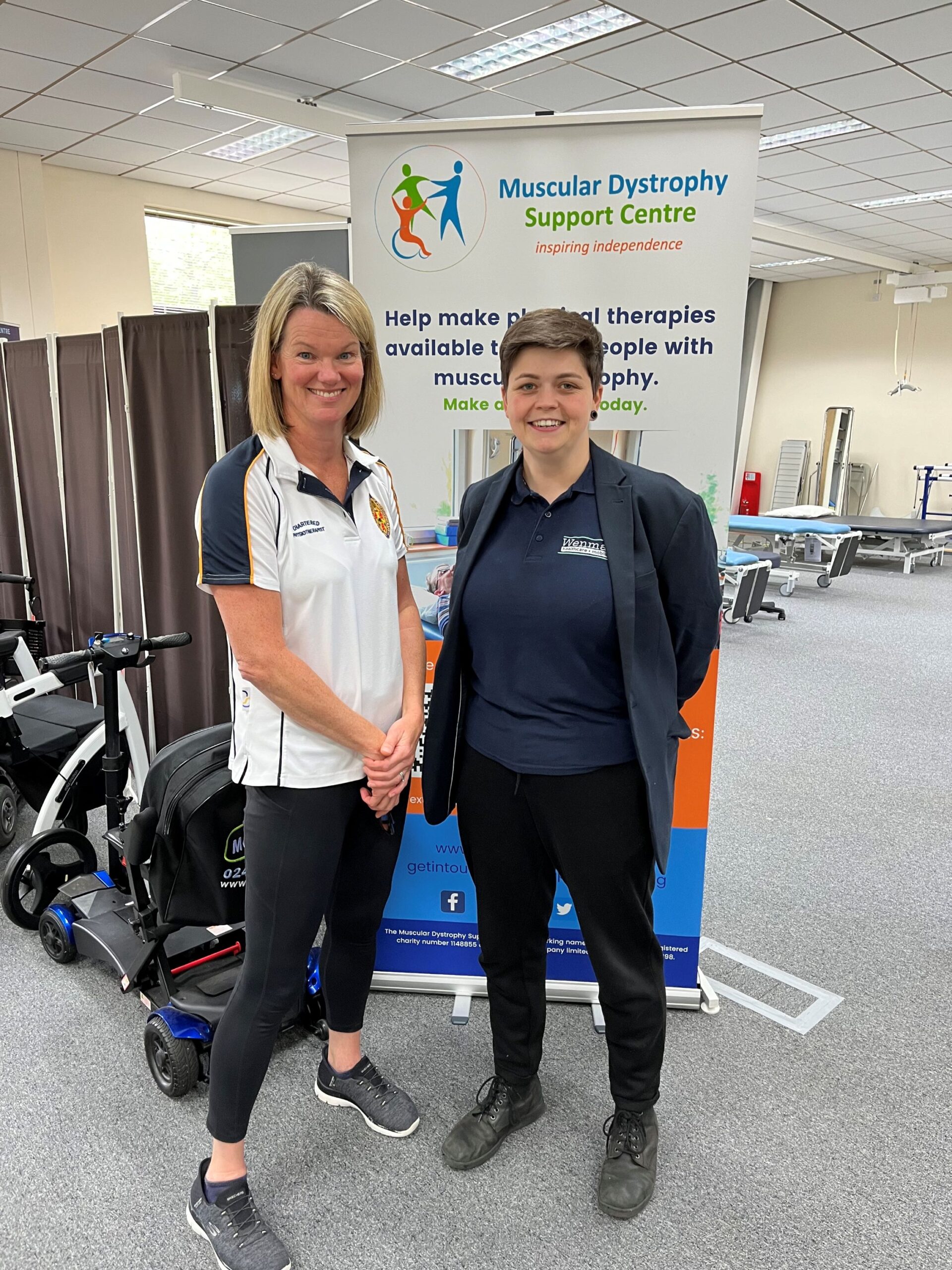 A therapist and a representative from Wenman Healthcare standing in MD Support Centre's therapy space.