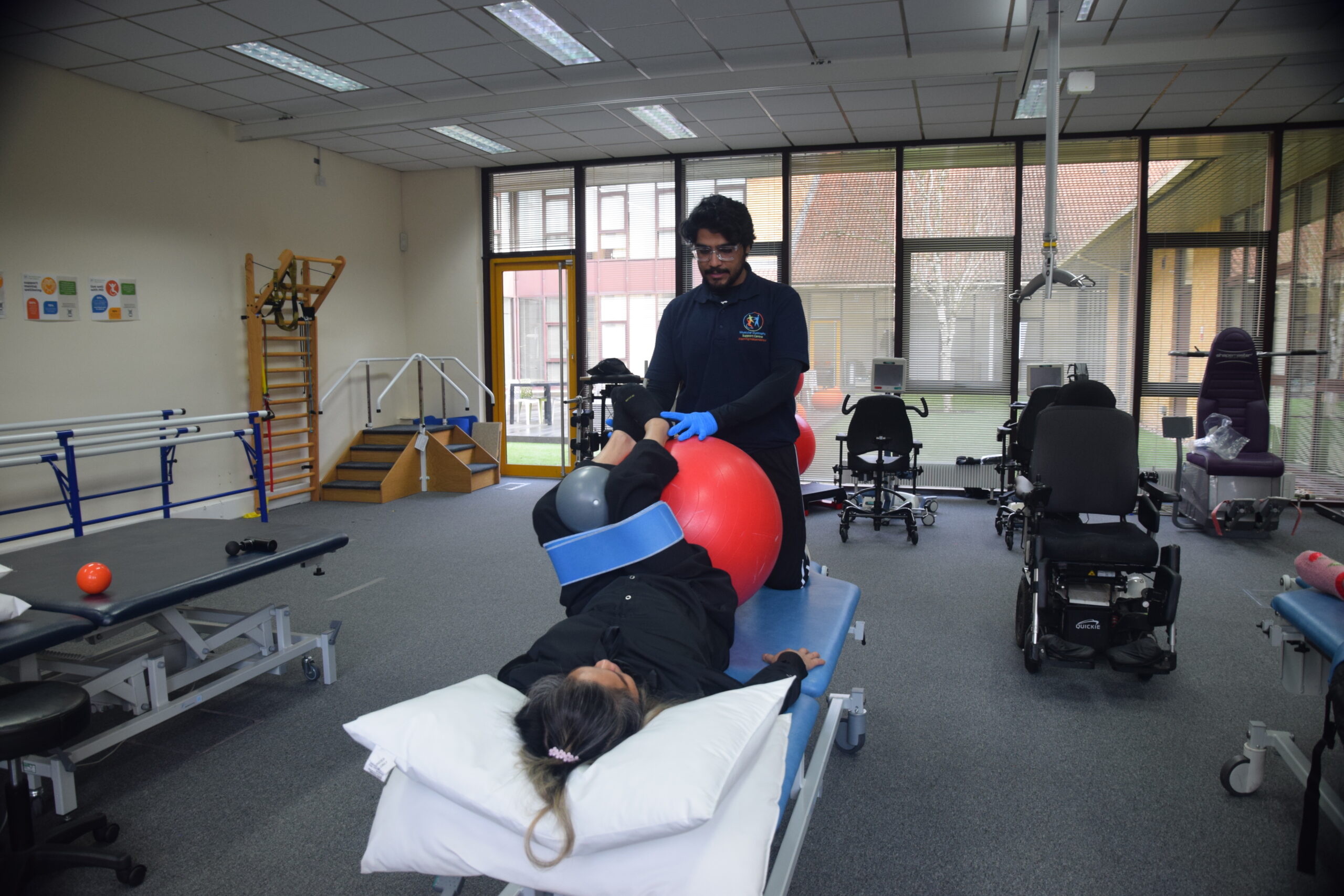 A physiotherapist treating a patient on a therapy bed.