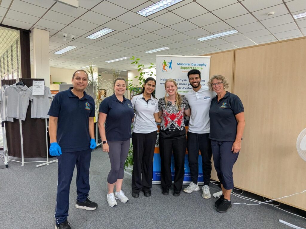 A group of people standing in MD Support Centre's reception area